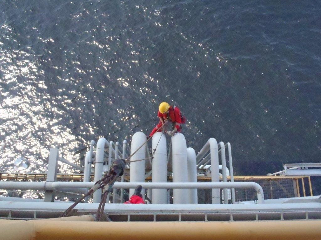 Men performing inspection using rope access