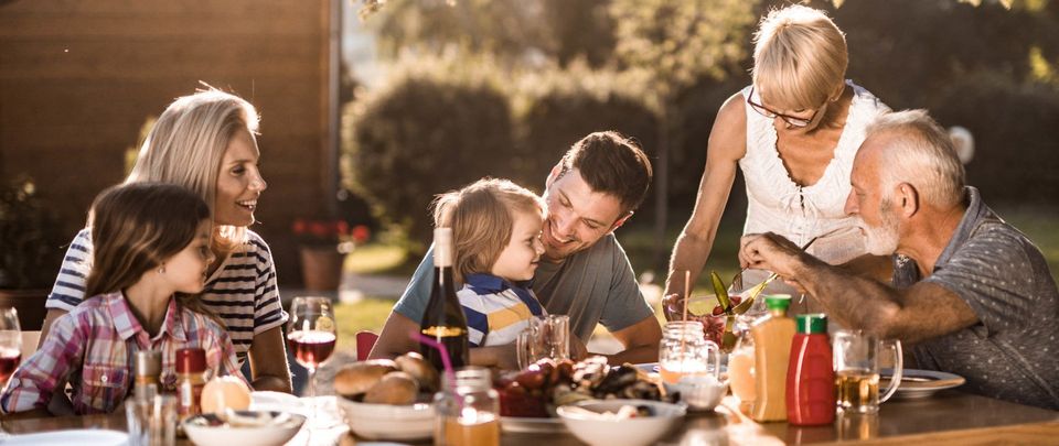 family sitting at a table outside