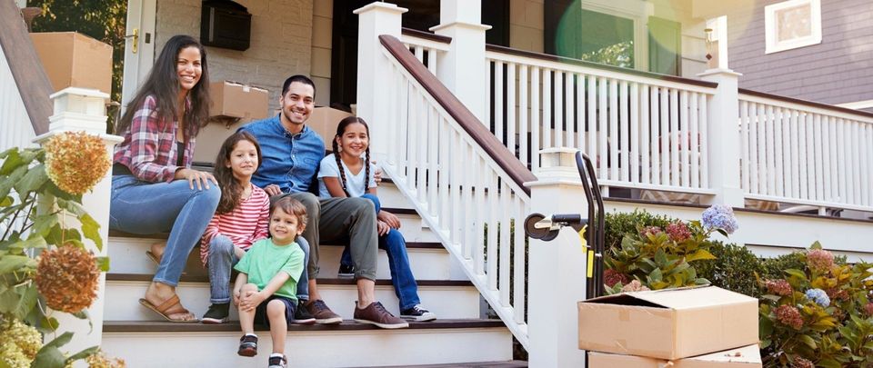 family sitting on home steps