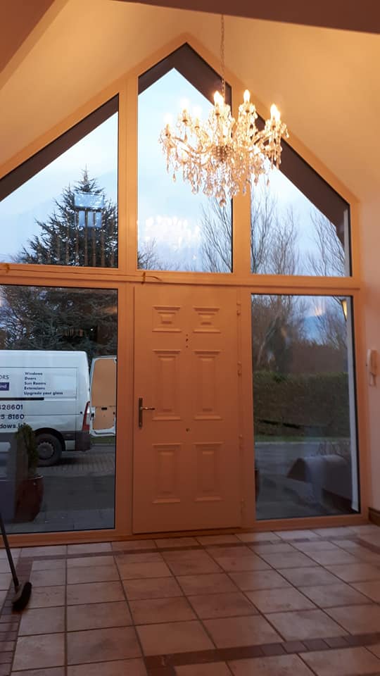 uPVC windows surrounding a front door on the top and both sides with a pointed triangle top