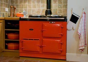 For AGA repairs call us today A red AGA cooker in a kitchen