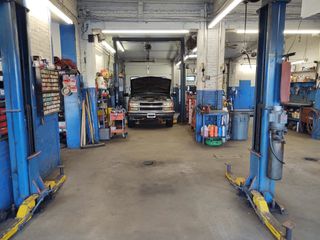 Mechanic examining car engine - repair in Worcester, MA Mechanic examining car engine - repair in Worcester, MA