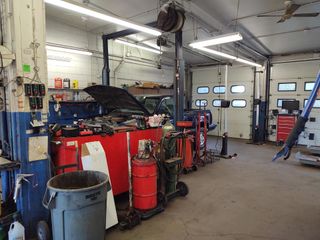Mechanic checking the engine - Alignments in Worcester, MA