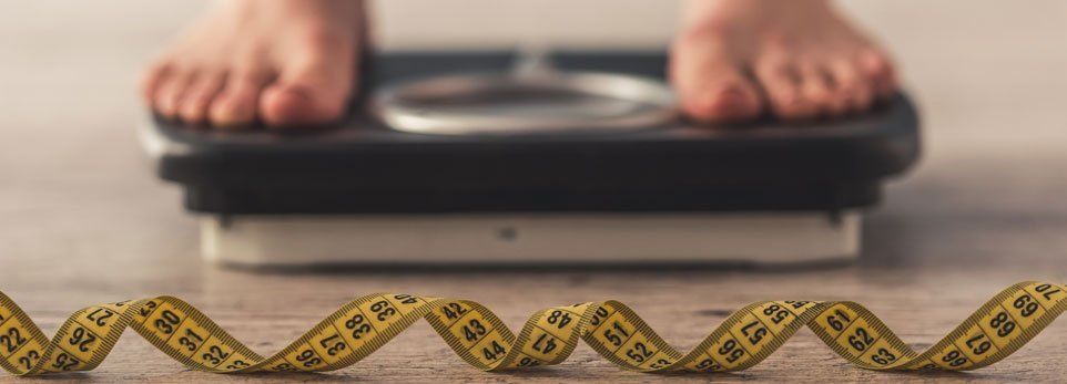piedi su una bilancia e metro, concetto di anoressia