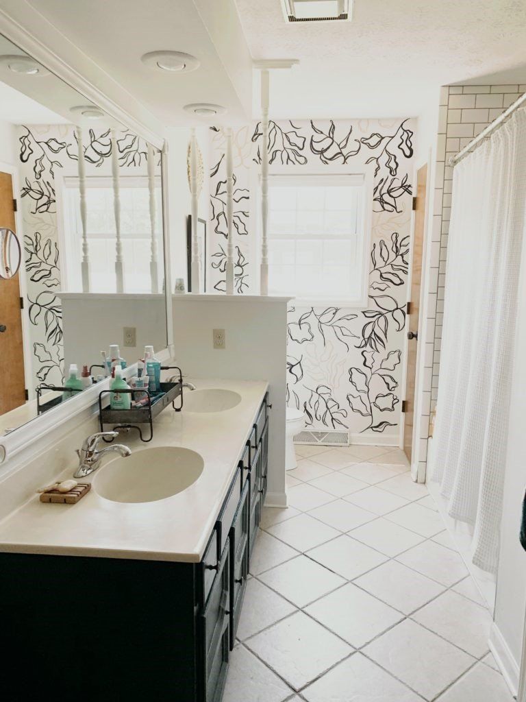 white bathroom with organic hand painted black and tan branches accent wall