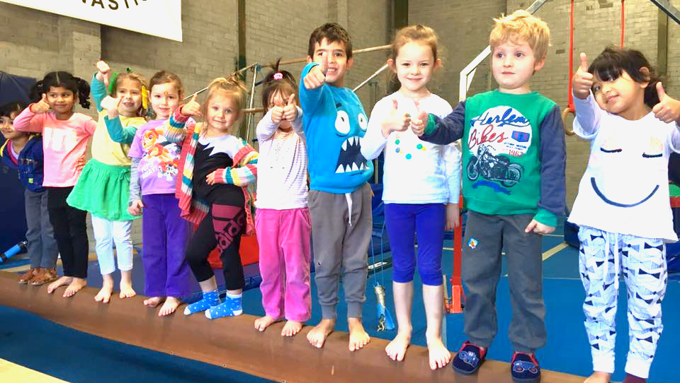 Trainer training a young gymnasts