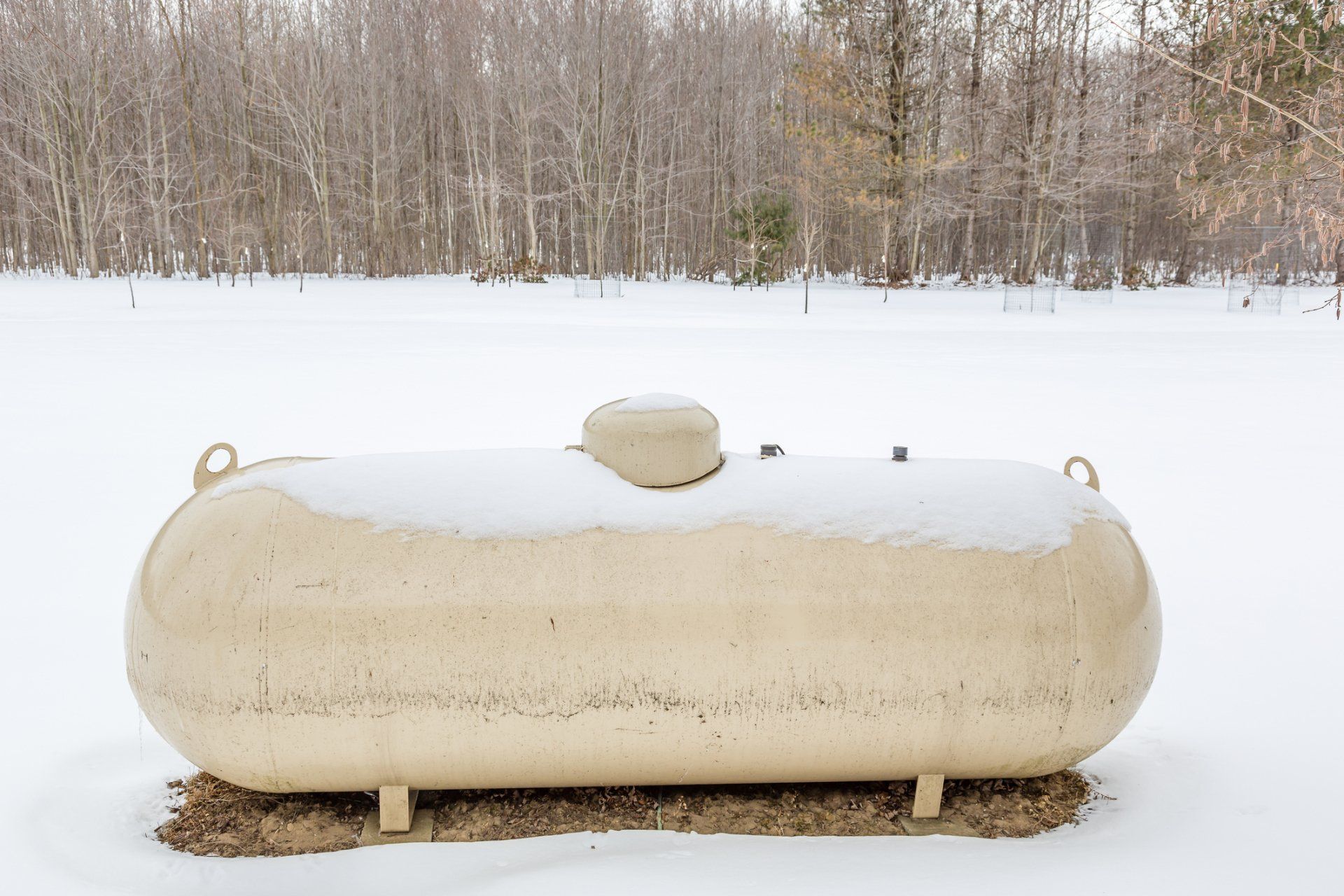 Tank Removal — Propane Tank Covered Partially With Snow in Fitchburg, MA Tank Removal — Propane Tank Covered Partially With Snow in Fitchburg, MA