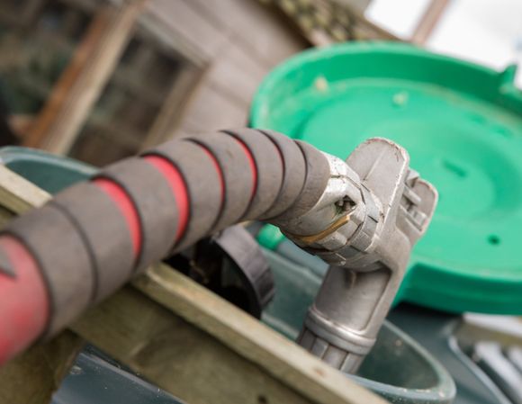 Fuel Assistance — Heating Oil Delivery, Nozzle Placed Into Tank Oil Refill in Fitchburg, MA Fuel Assistance — Heating Oil Delivery, Nozzle Placed Into Tank Oil Refill in Fitchburg, MA