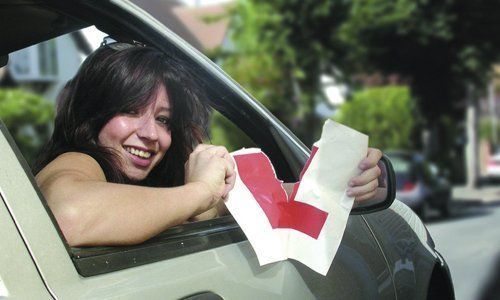 A woman tearing the L plaque