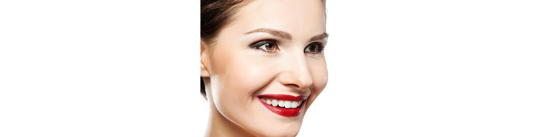 A smiling person with dark red lipstick looks to the right against a white background.