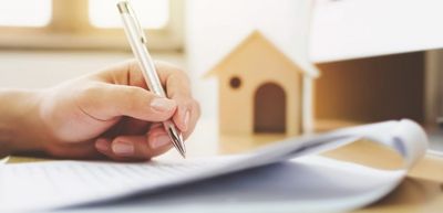 image of hand with pen and paper
