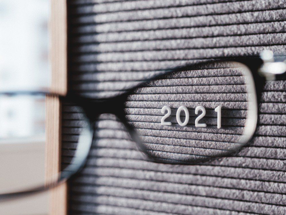 A pair of glasses with the year 2021 written on them.