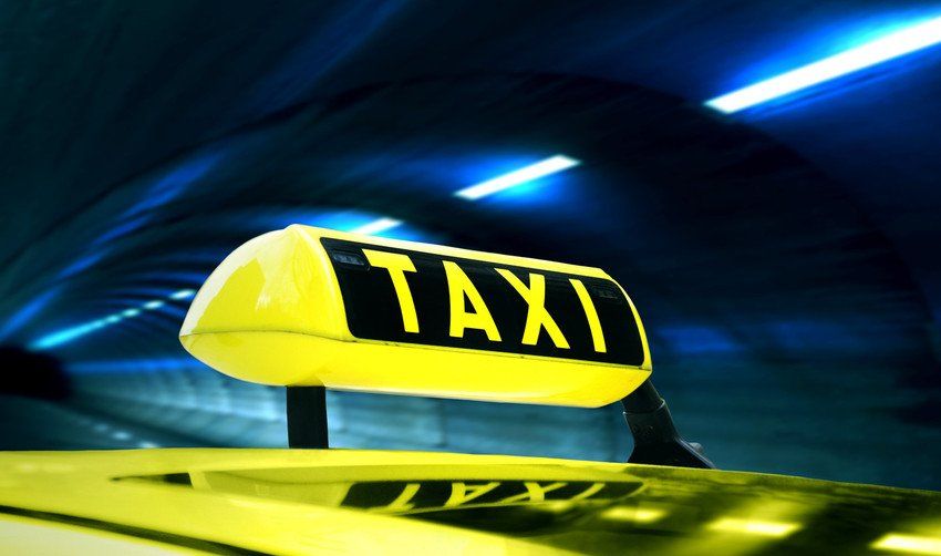taxi sign on the cab highlighted in yellow and black