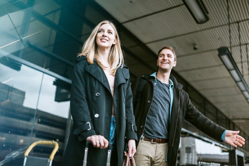 a couple arrived at an airport and waiting for their cab