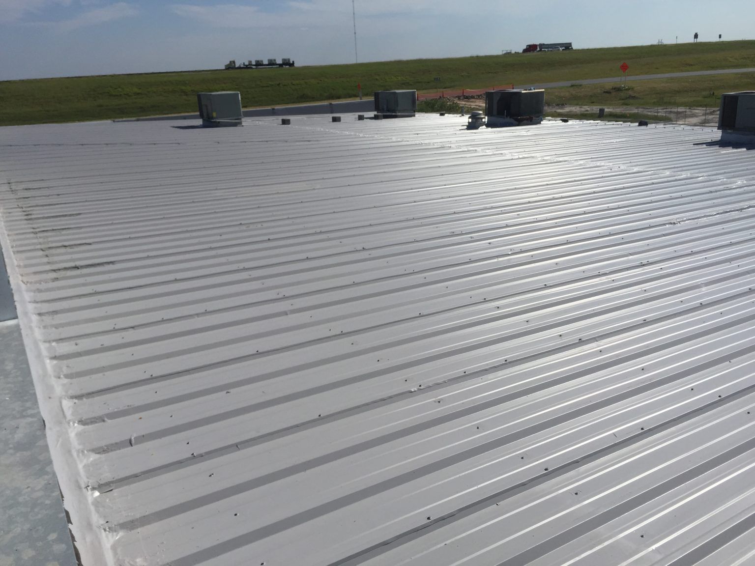 a white roof with a field in the background