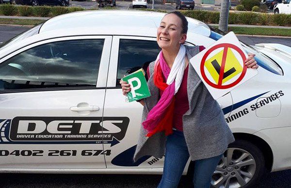 newly licensed girl next to car