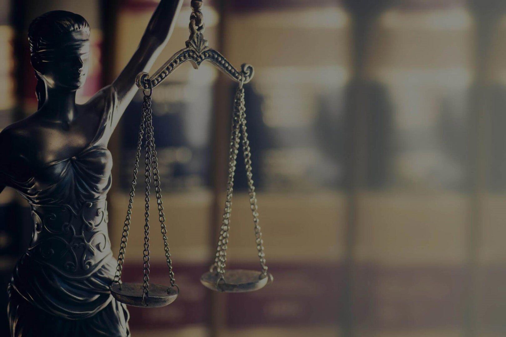 Statue of Lady Justice holding scales, set in a law office.