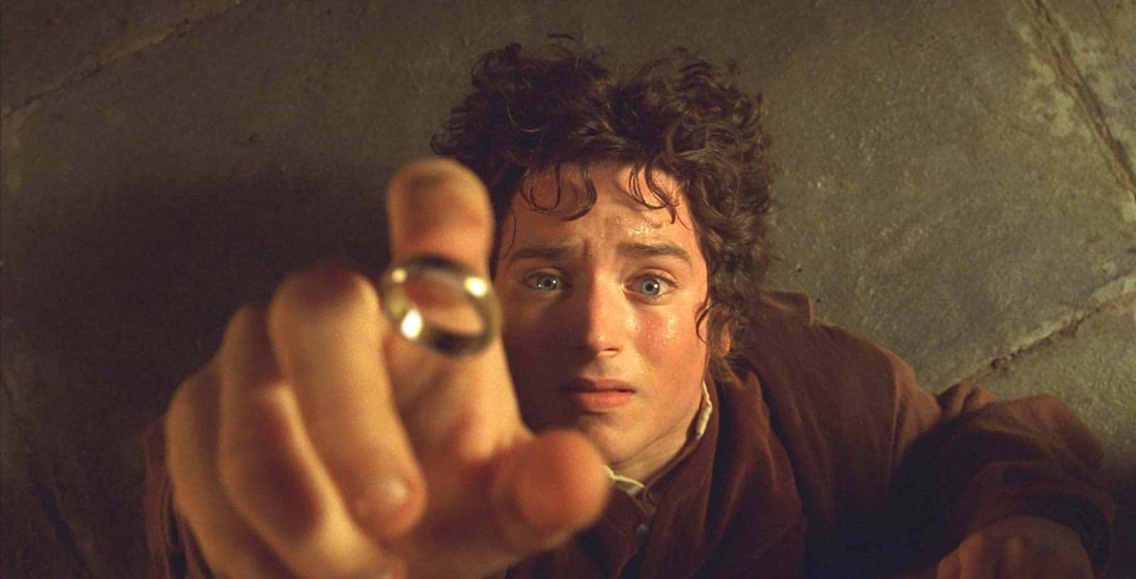 A man is pointing at a ring on his finger.