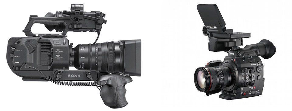 Two cameras are sitting next to each other on a white background.