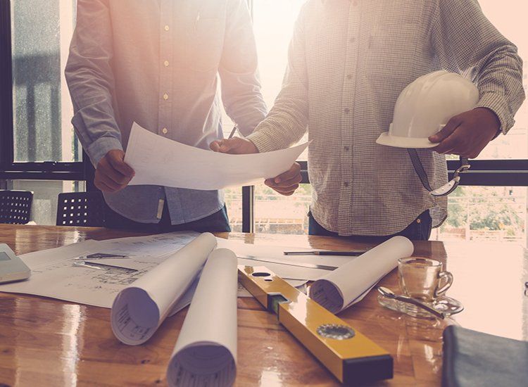 Planners Looking Over House Blueprint — River City Certifiers in Taree NSW