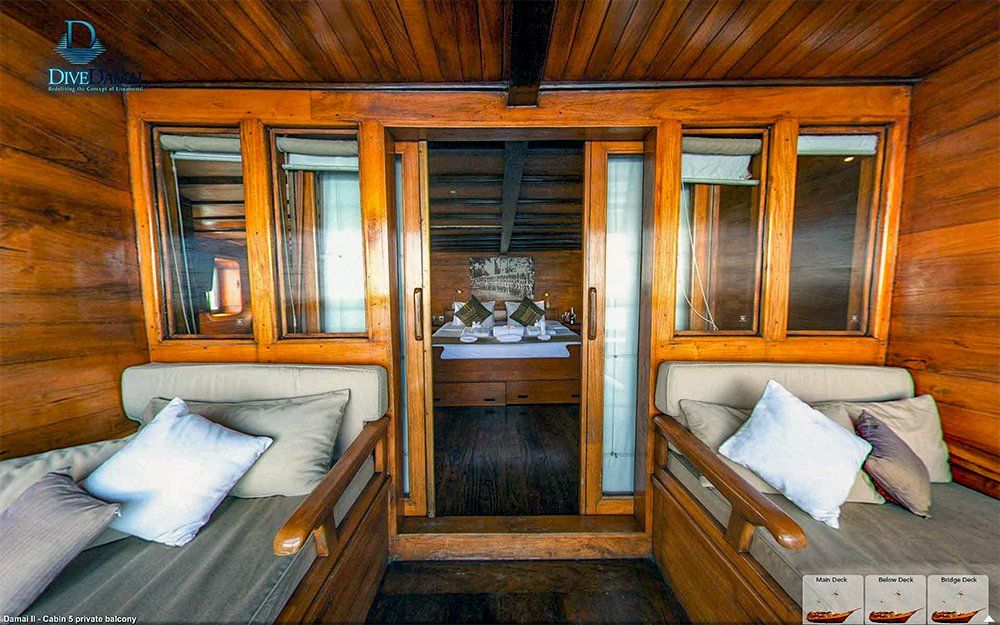 Wooden room with two cushioned benches facing each other. A doorway leads to a bright interior.