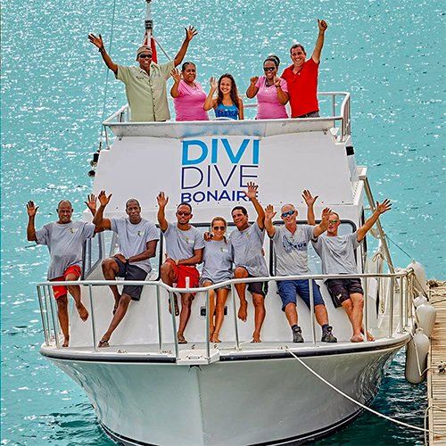 Group of people waving from a boat,