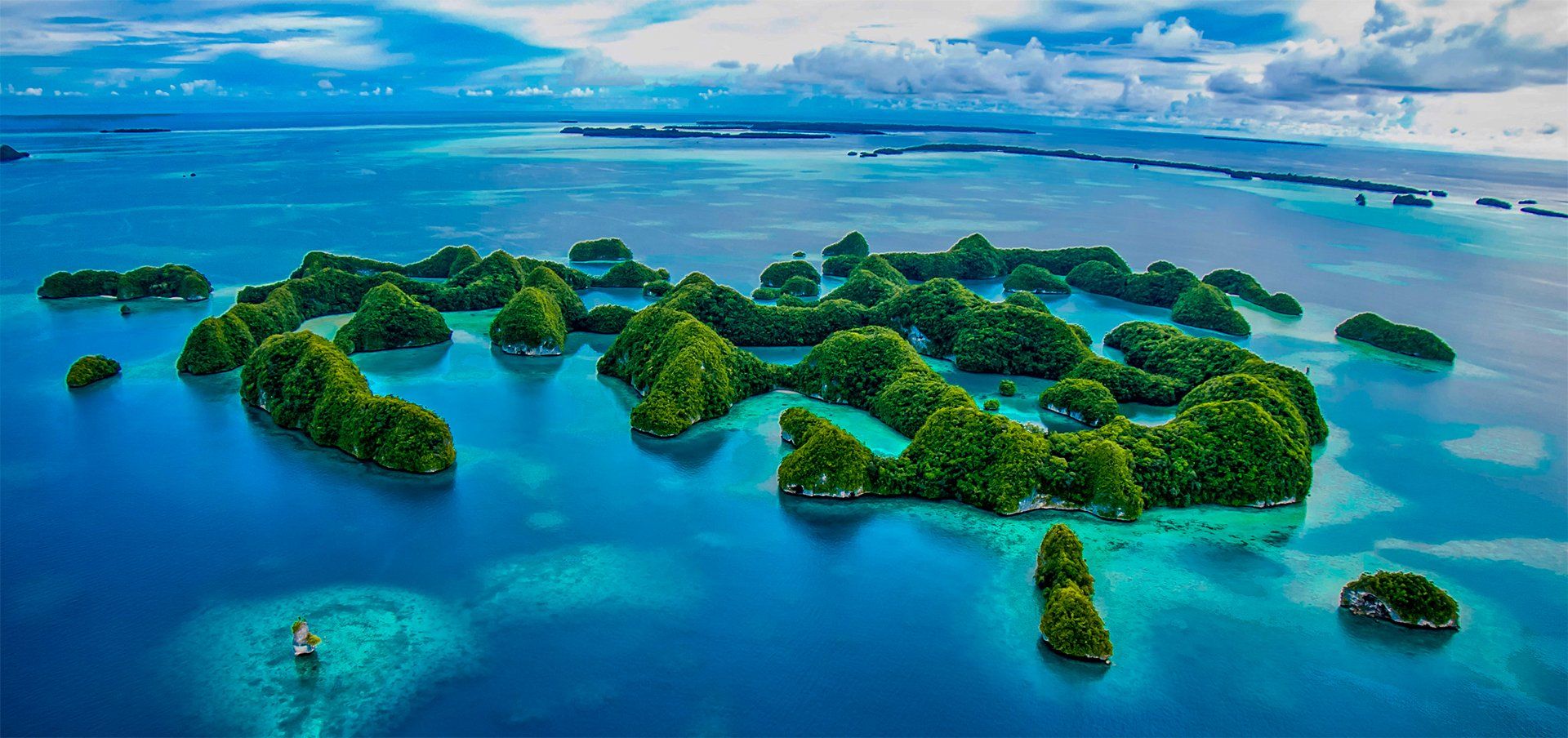 Aerial view of tropical islands surrounded by blue ocean.