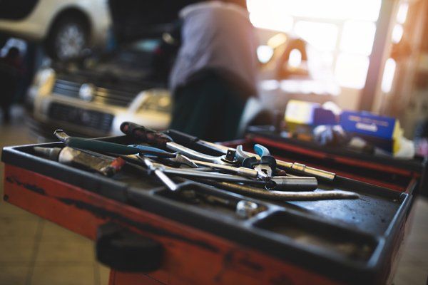 tools and mechanic working on car