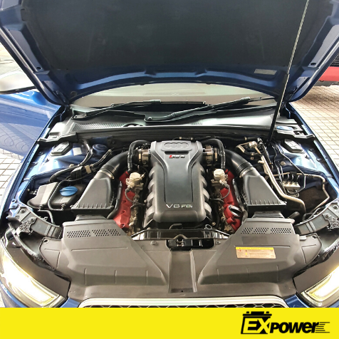 Blue sports car with hood open, showing a V10 engine bay and aftermarket red intake components.