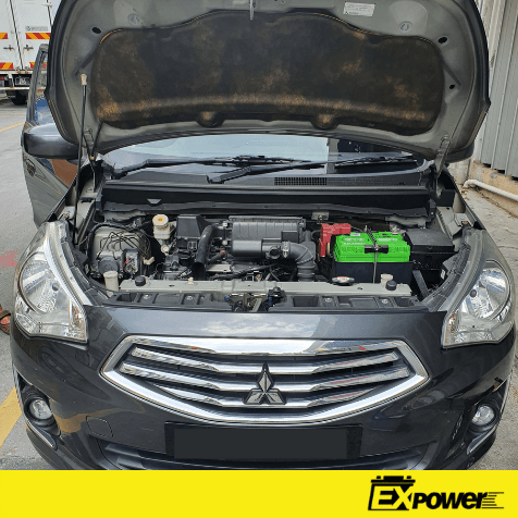 Black Mitsubishi sedan with hood open, showing the engine compartment.