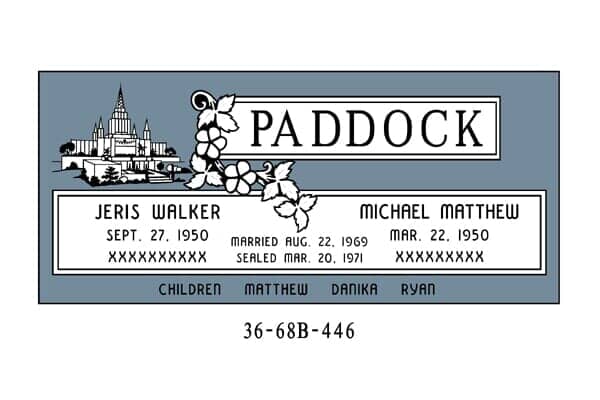 Gravestone of the Paddock family, featuring names, birth/death dates, and a church.