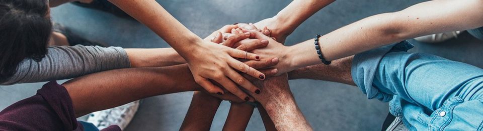 College Students With all hands in | Red Brick Property Management LLC