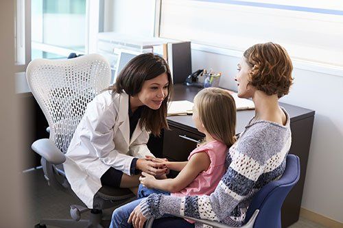 parent and child with doctor