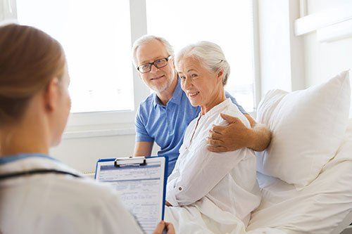 mature adults sitting with doctor