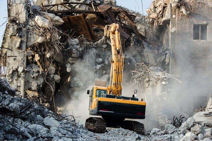 Commercial Demolition — Excavator Demolishing A Commercial Space in Austin, TX Commercial Demolition — Excavator Demolishing A Commercial Space in Austin, TX