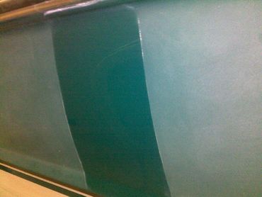 Gelcoat surface showing repaired section versus oxidized and faded finish