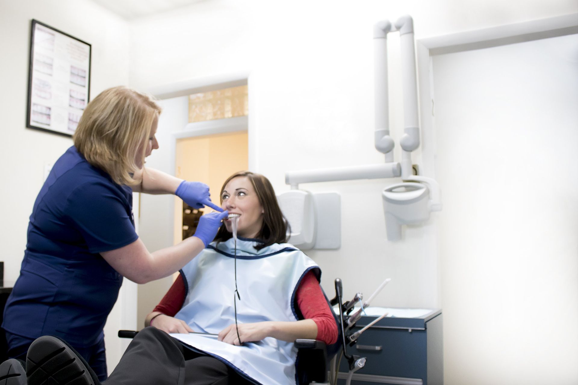 dentist assisting patient