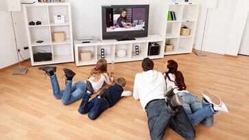 Family watching tv — Family in Carlsbad, CA Family watching tv — Family in Carlsbad, CA