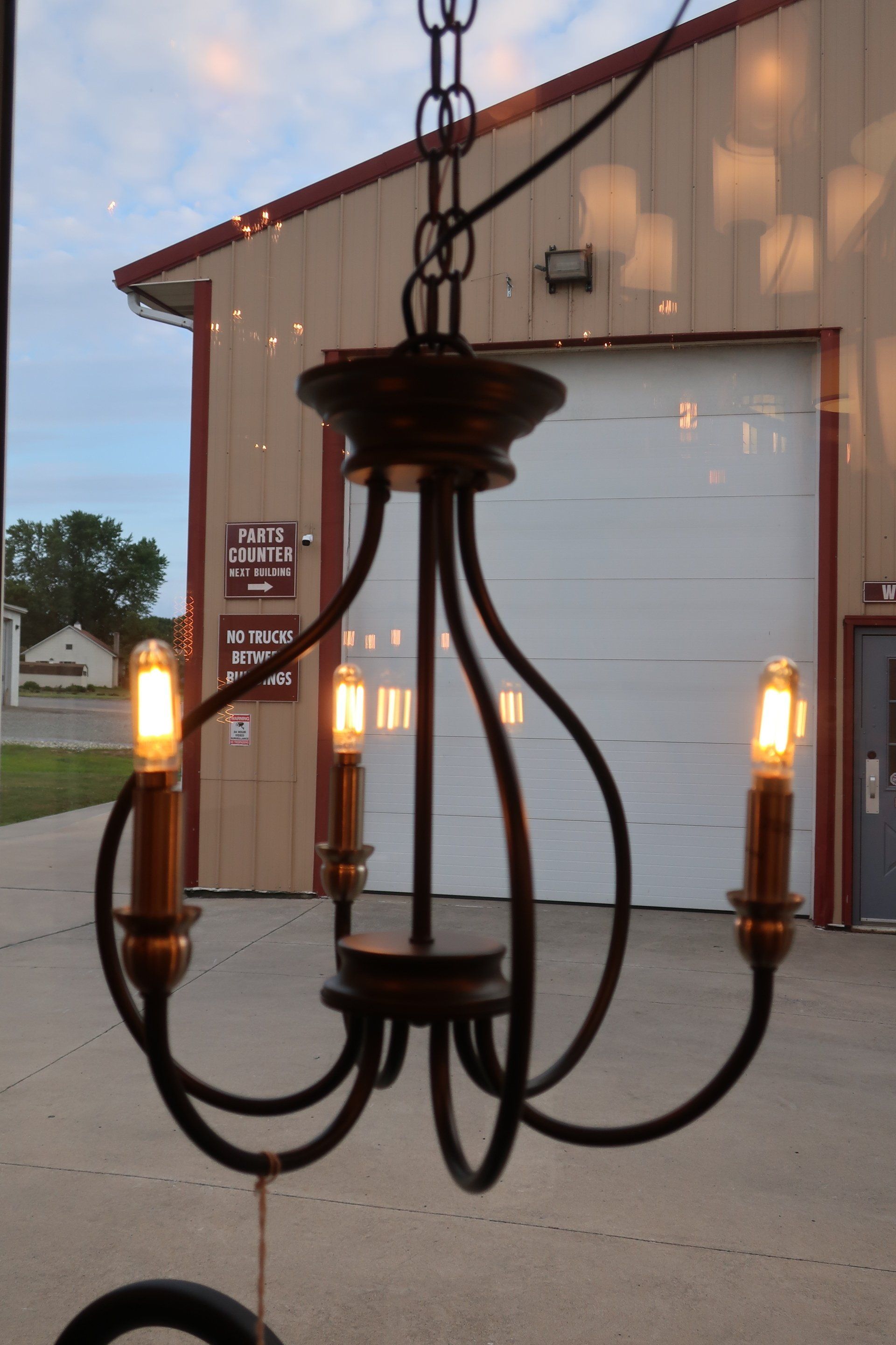 A chandelier is hanging from the ceiling in front of a garage door