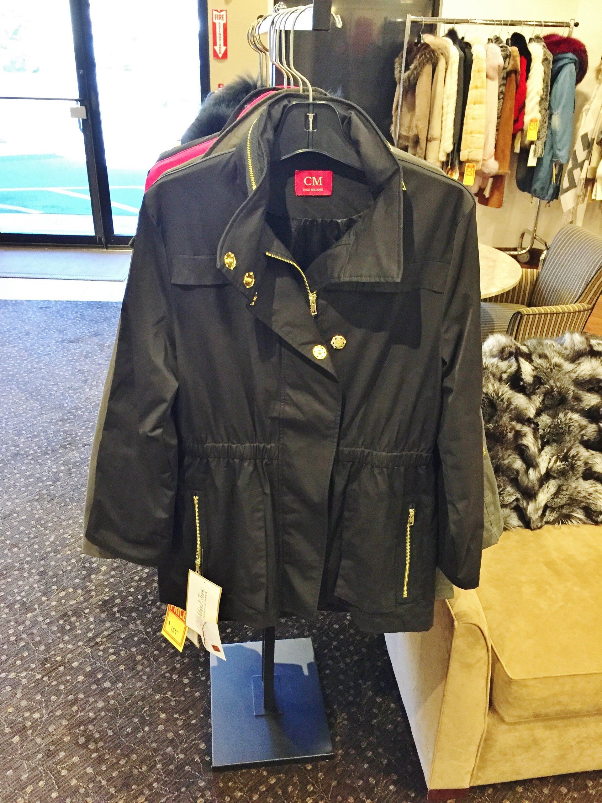 A black jacket is hanging on a rack in a store