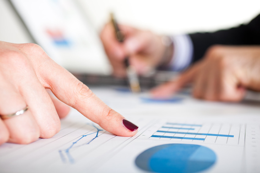 Business people reading business graphs and charts