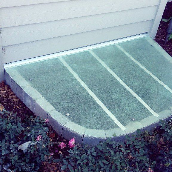 A window well with a glass cover on it
