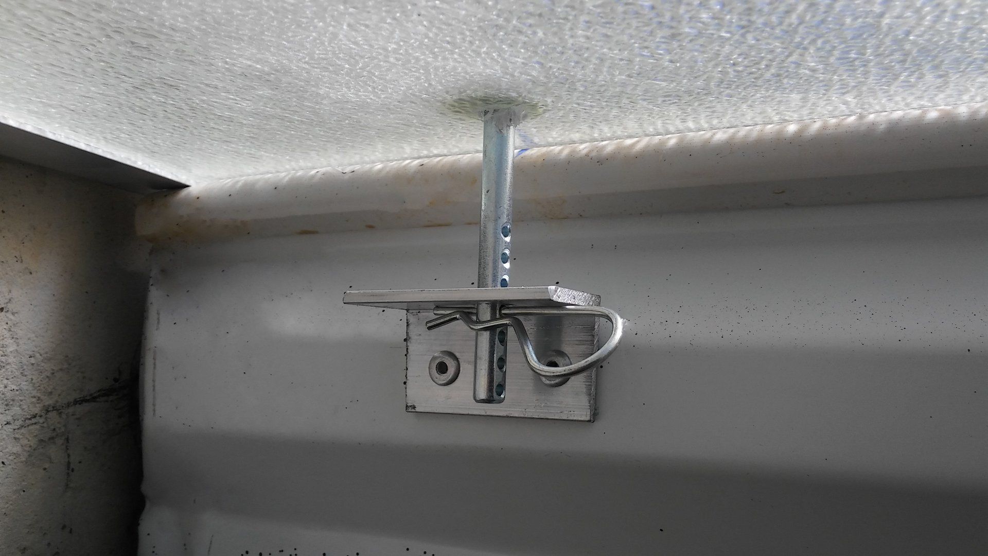 A close up of a metal hook on a wall.