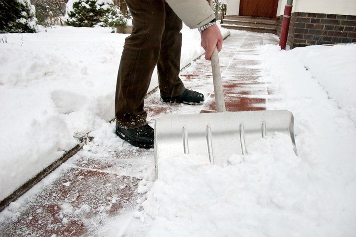 Man Shoveling Snow — Columbus, OH — CBJ Landscape Group