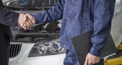 mechanic and client shaking hands
