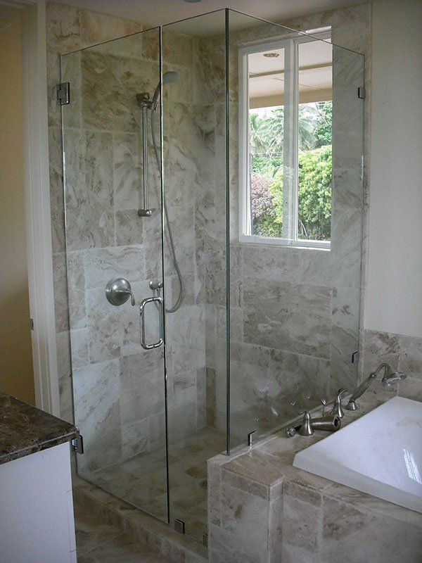 one door shower with marble grey and tan tiling