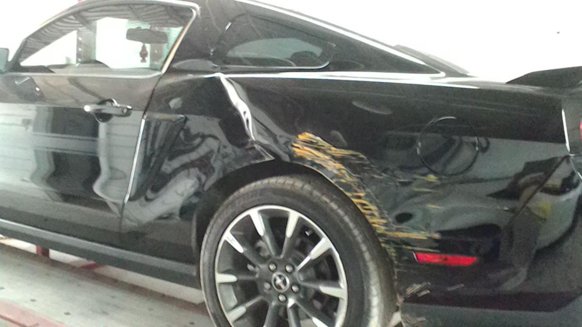 black car with yellow paint on the side