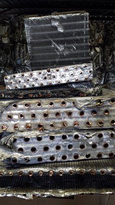 A close up of a stack of metal pieces with holes in them.