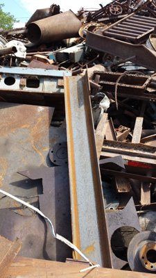 A pile of rusty metal is sitting on the ground