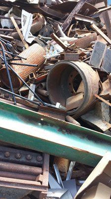 A pile of scrap metal is sitting on top of a green table.